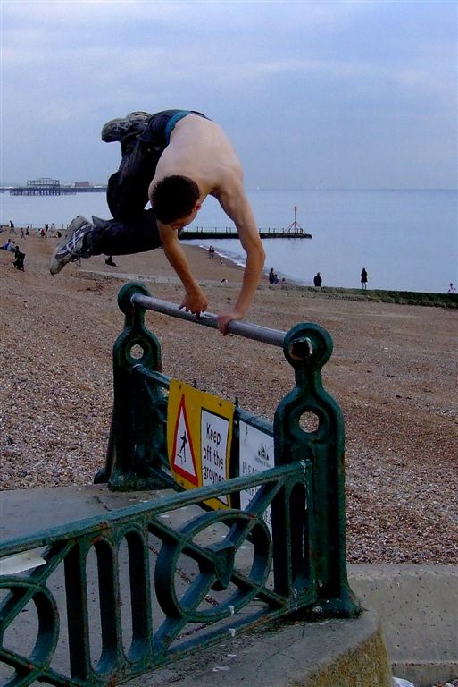 the man is doing a skateboard trick on the railing