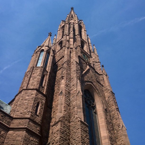 tall brick church against a blue sky