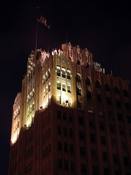 the top of a large building lit up at night