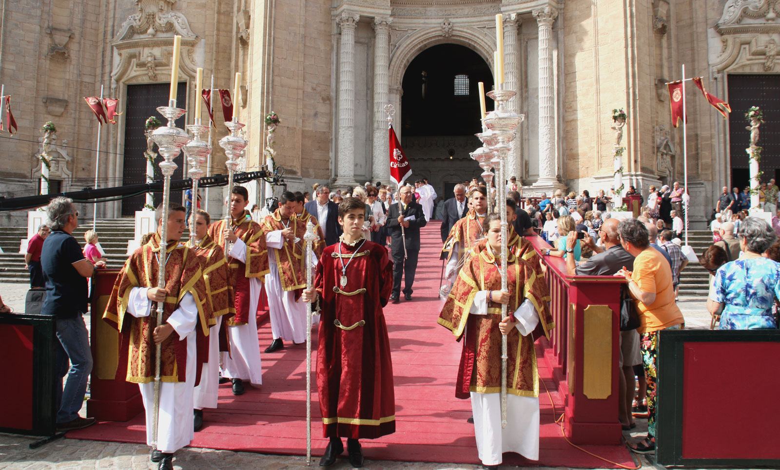 a line of men in red and white uniforms walking on a street