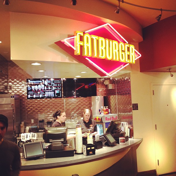 people are behind a fast food restaurant counter