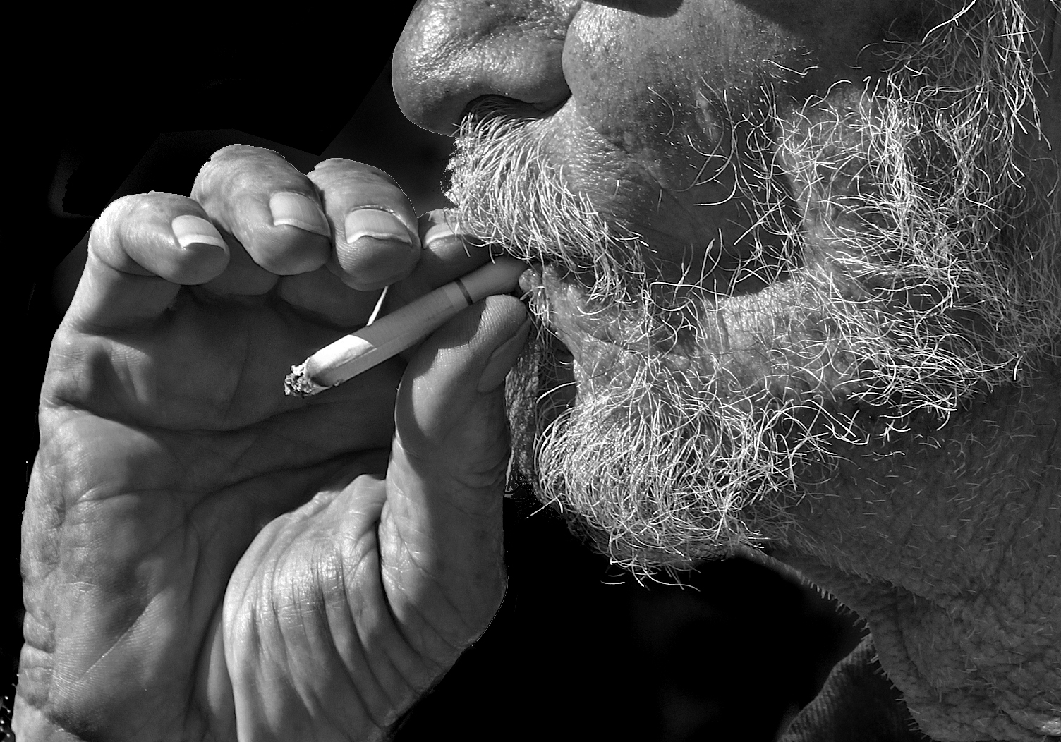 black and white po of a man using a cigarette