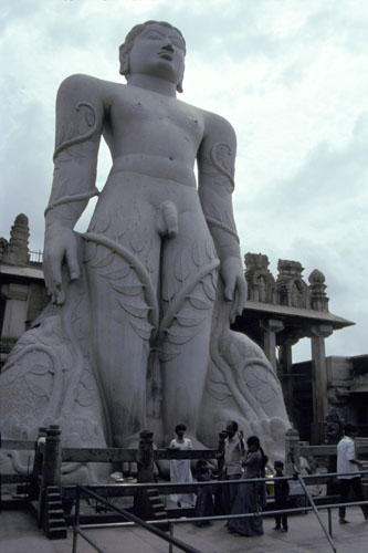statue of a god in front of a statue of a woman in a body