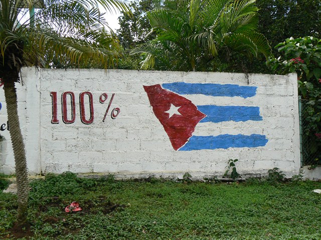 a white brick wall with a painted map of cuba