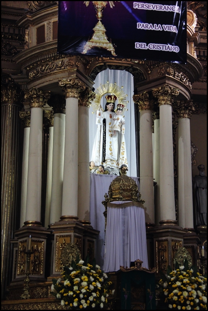 a statue on display next to columns inside a church