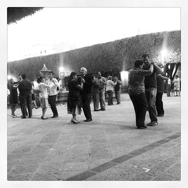 a group of people standing outside at night