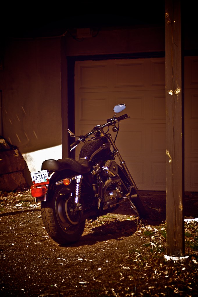 a motorcycle parked in front of a garage
