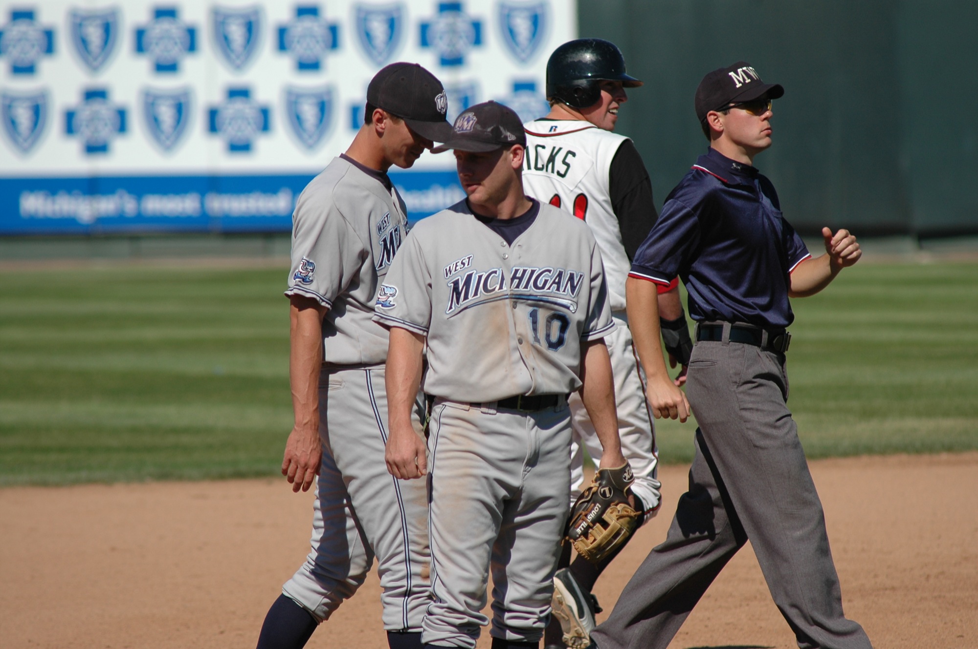 three baseball players are walking off the field