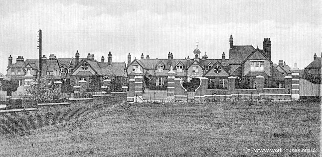 a black and white image of a city with some old houses