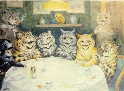 several cats sit at a round table with a white cloth