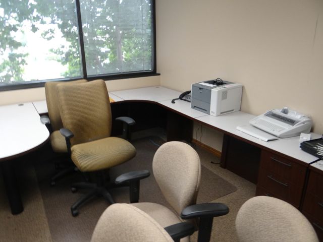 a home office setting with many desks