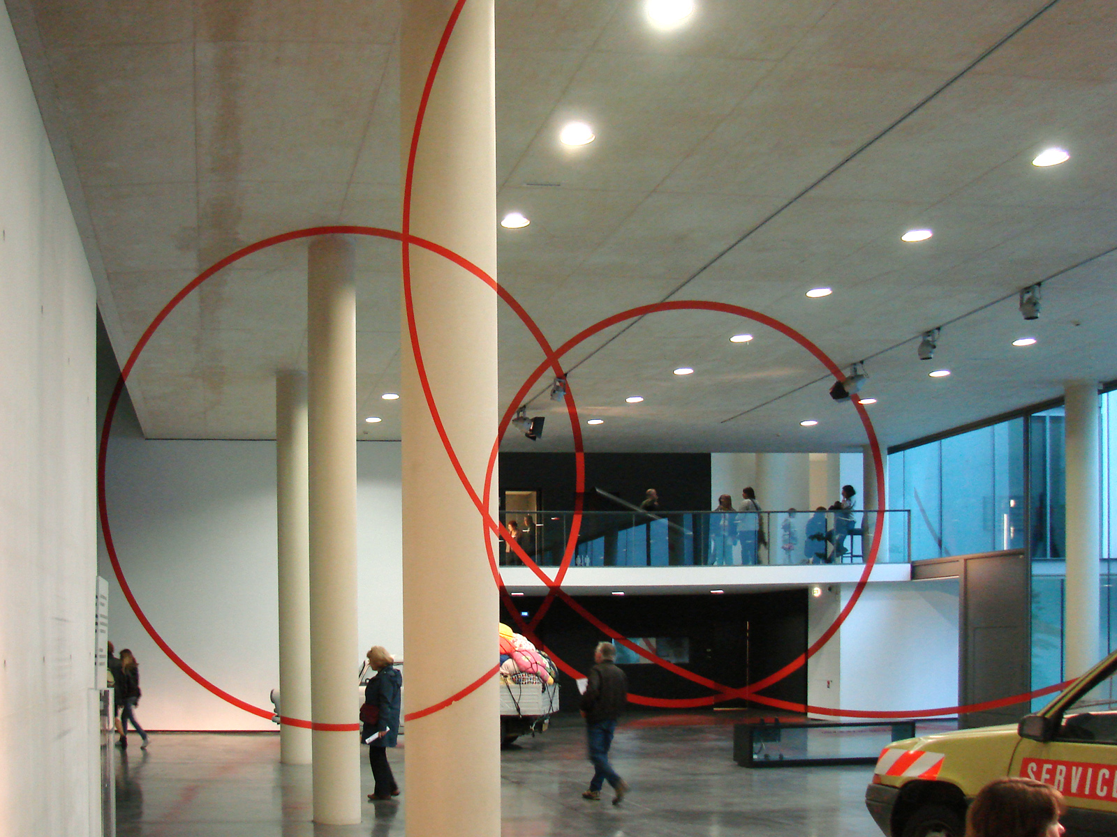 a man walking around in front of an art installation