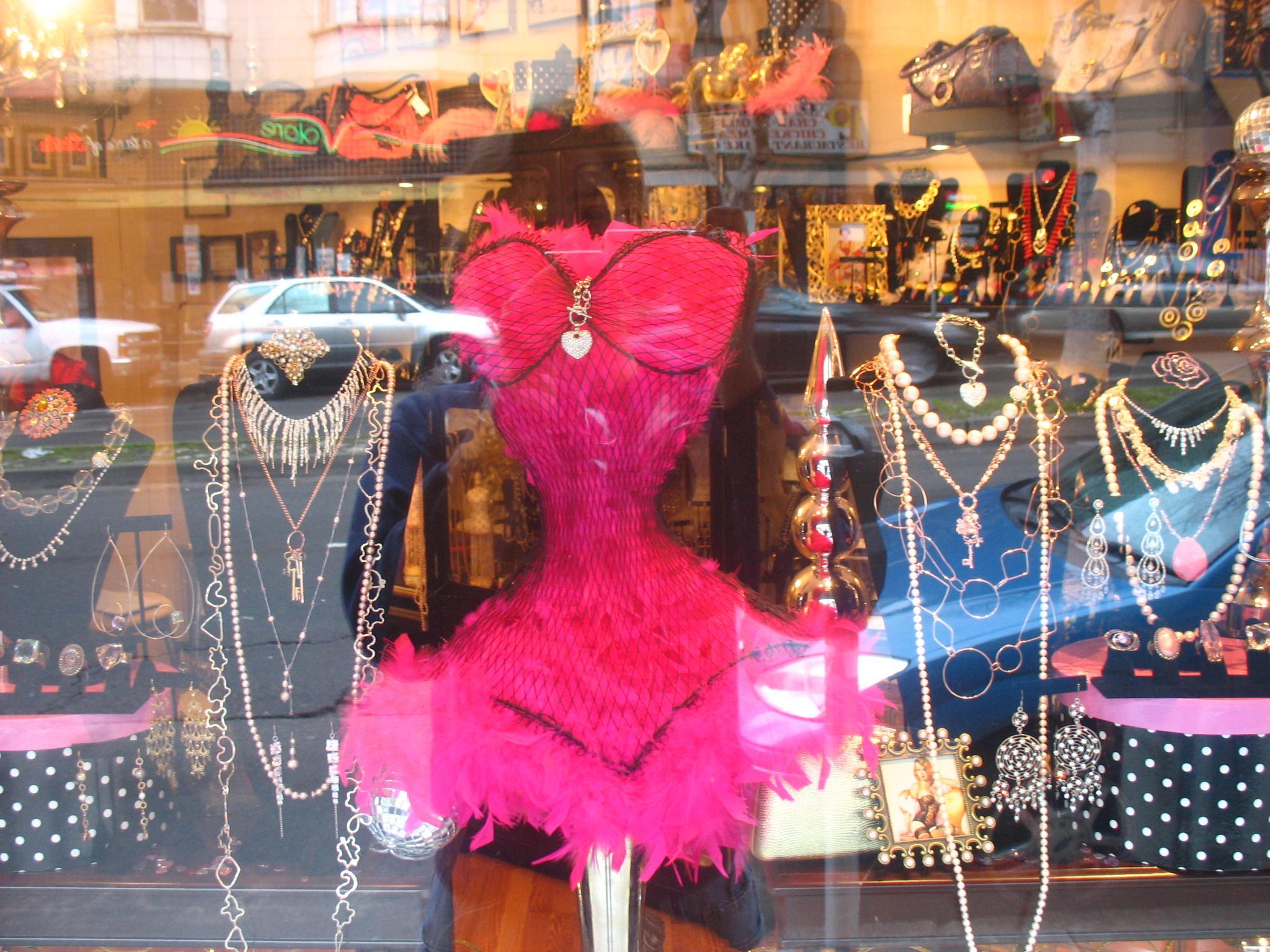 a store window with clothing on display in it