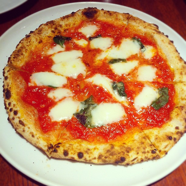 a pizza is served on a white plate