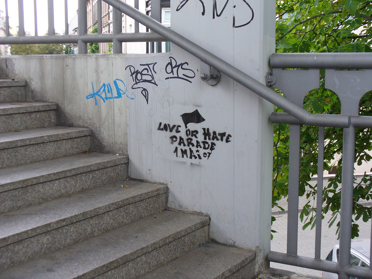 a bunch of graffiti on the wall above stairs