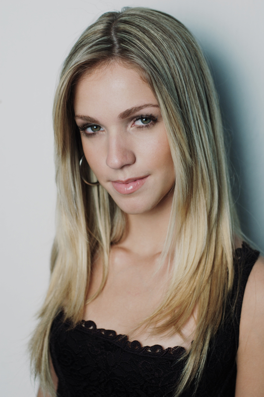 a young lady wearing a black shirt poses for a picture