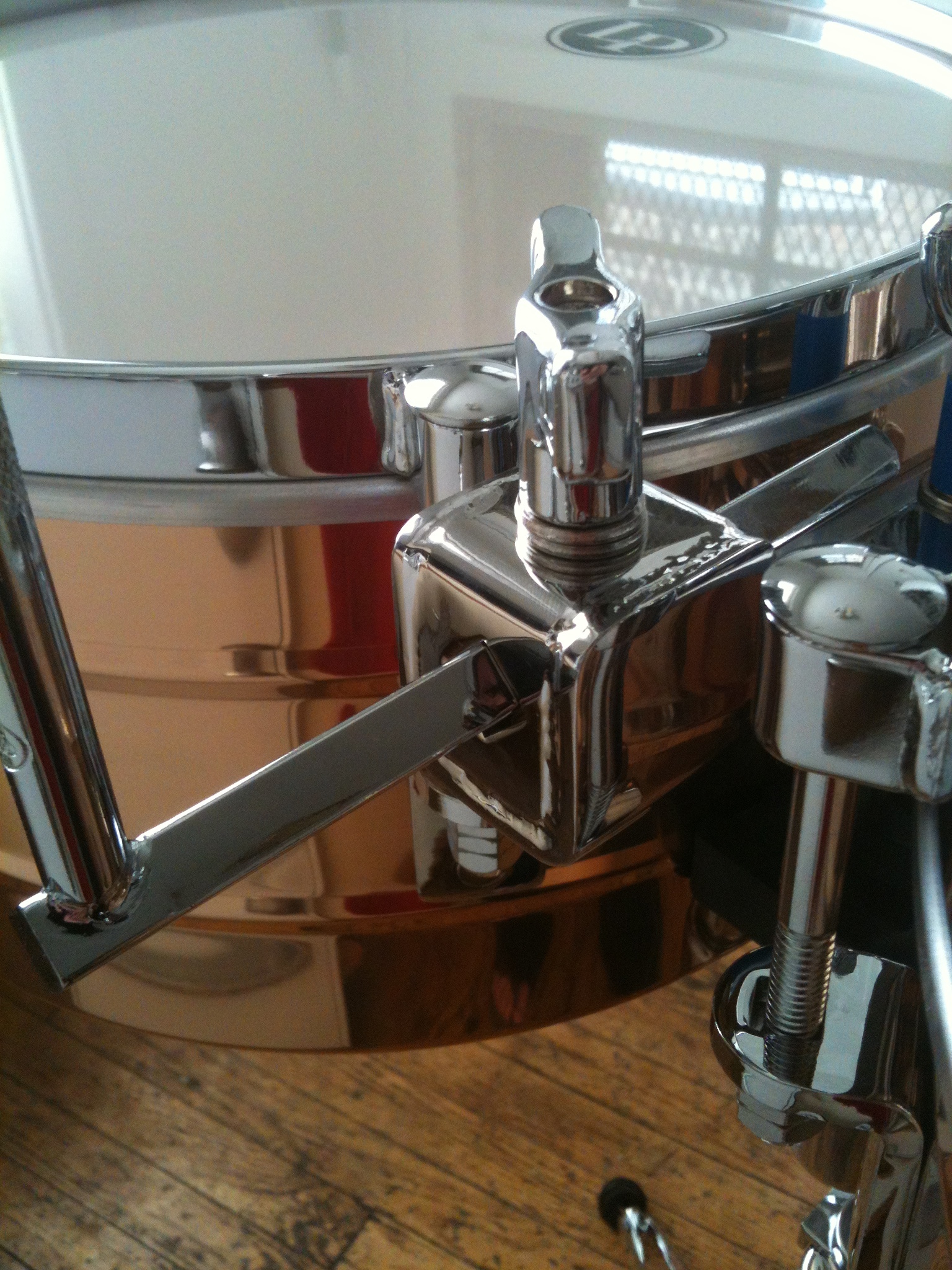 a close up of a snare drum with wood flooring