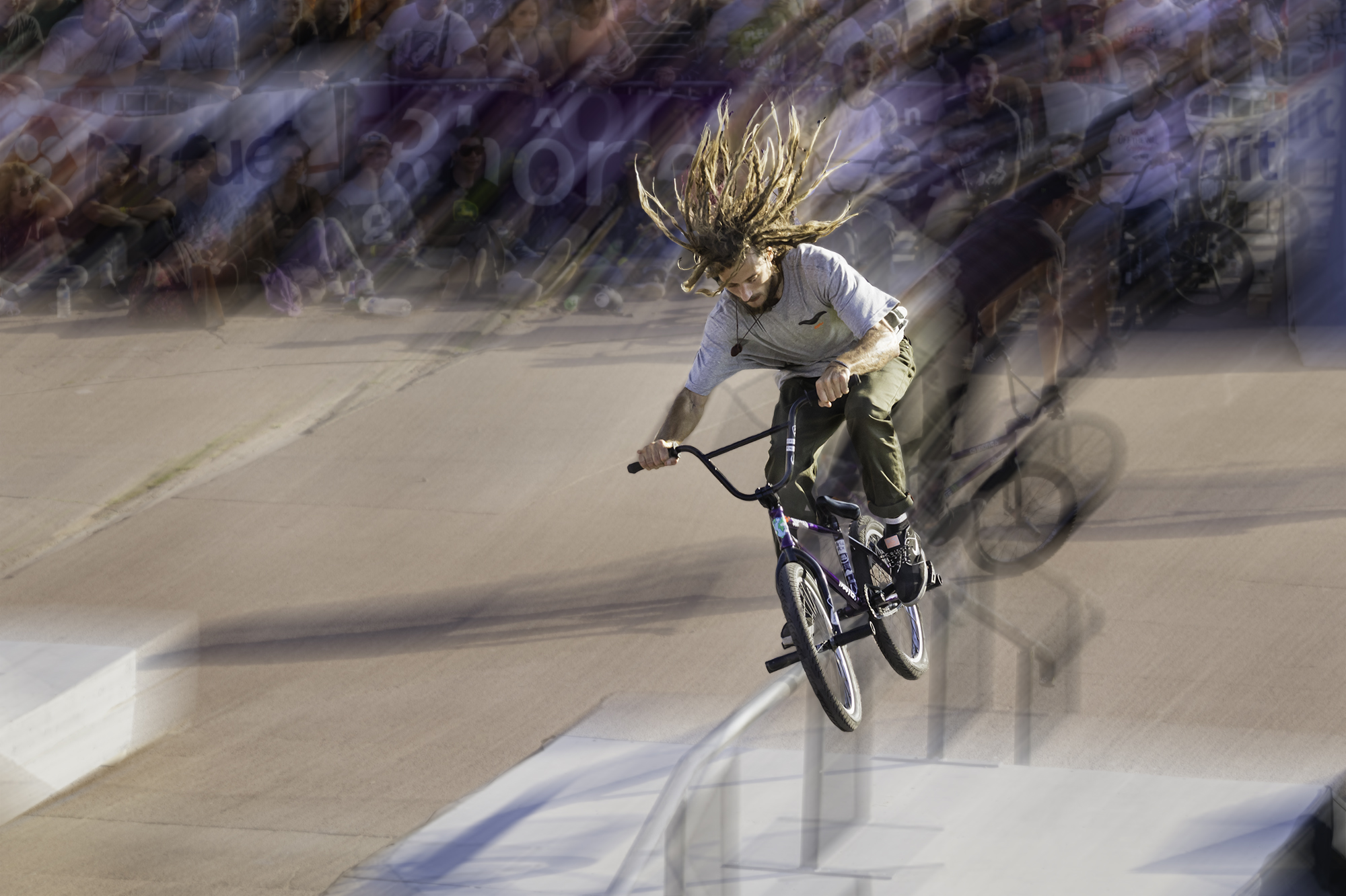 a person on a bicycle in front of a crowd of people