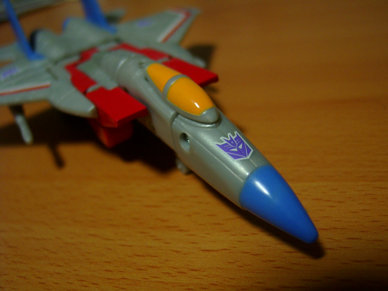 a toy airplane with a purple yellow and blue jet