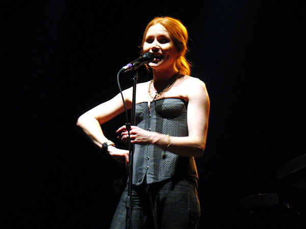 a woman standing in front of a microphone