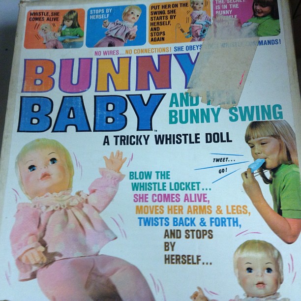 a childrens book with an image of a baby doll and a little girl in it