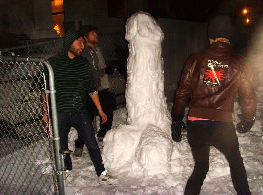 a group of men standing around a snow man