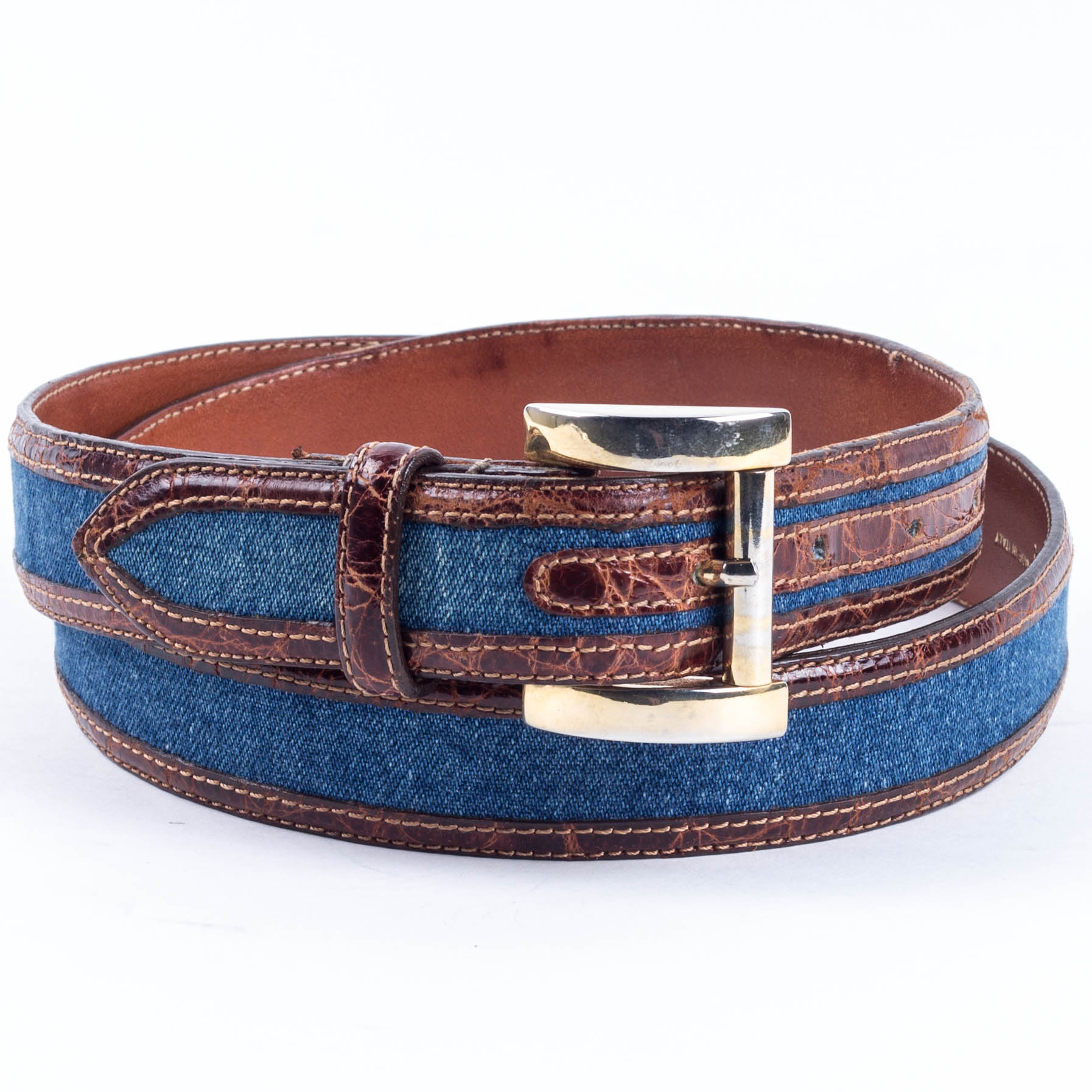 a belt with blue denim and gold buckle
