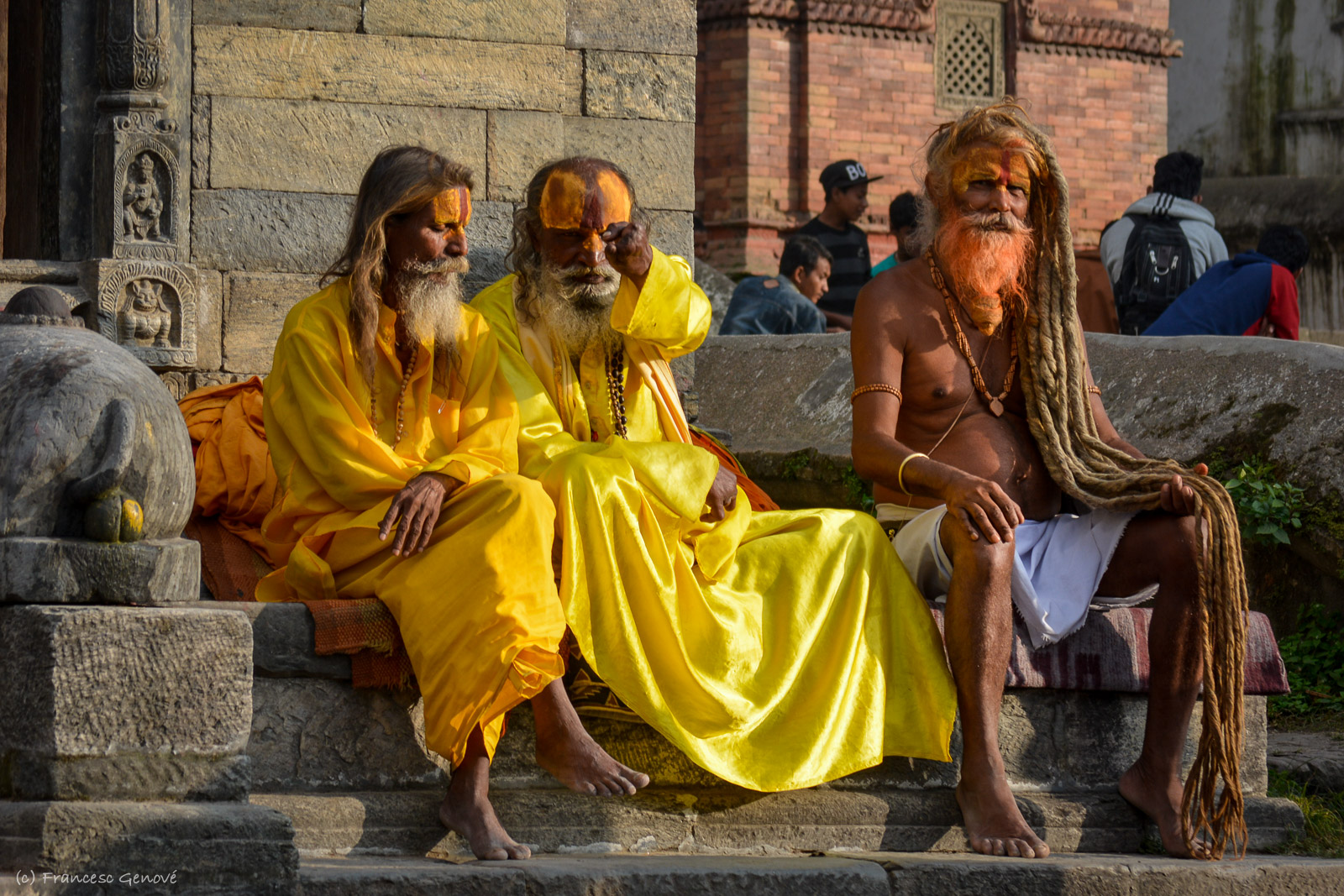 three people are sitting on the steps, dressed in costumes