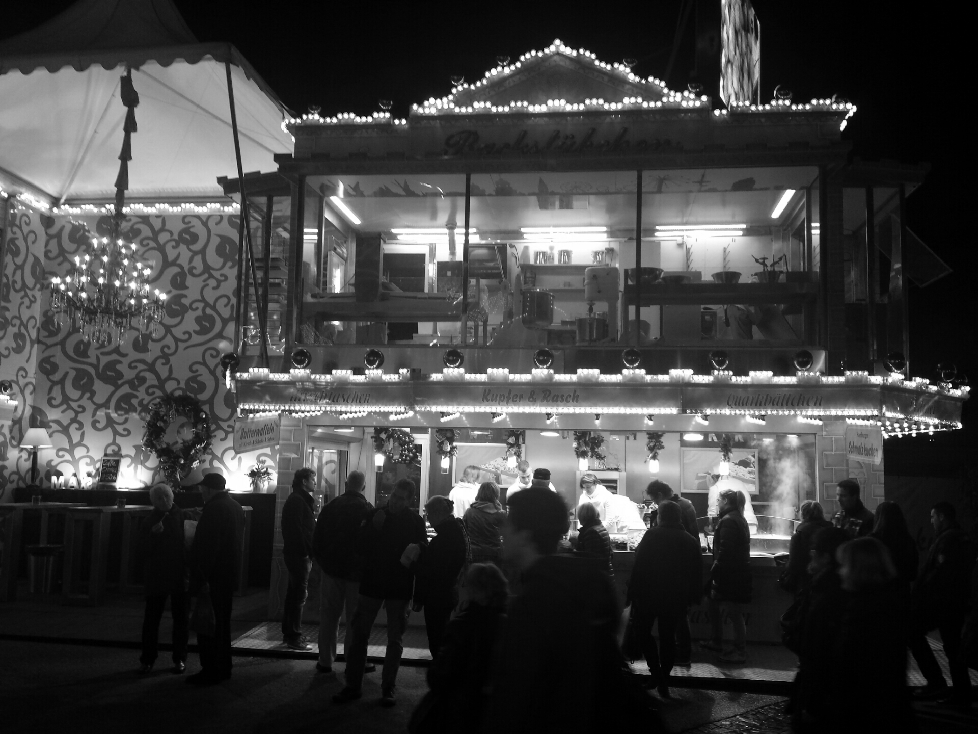 a carousel house with lots of people standing around outside
