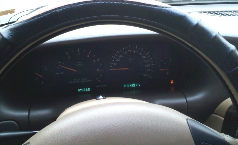 a car dashboard and dash lights and a steering wheel