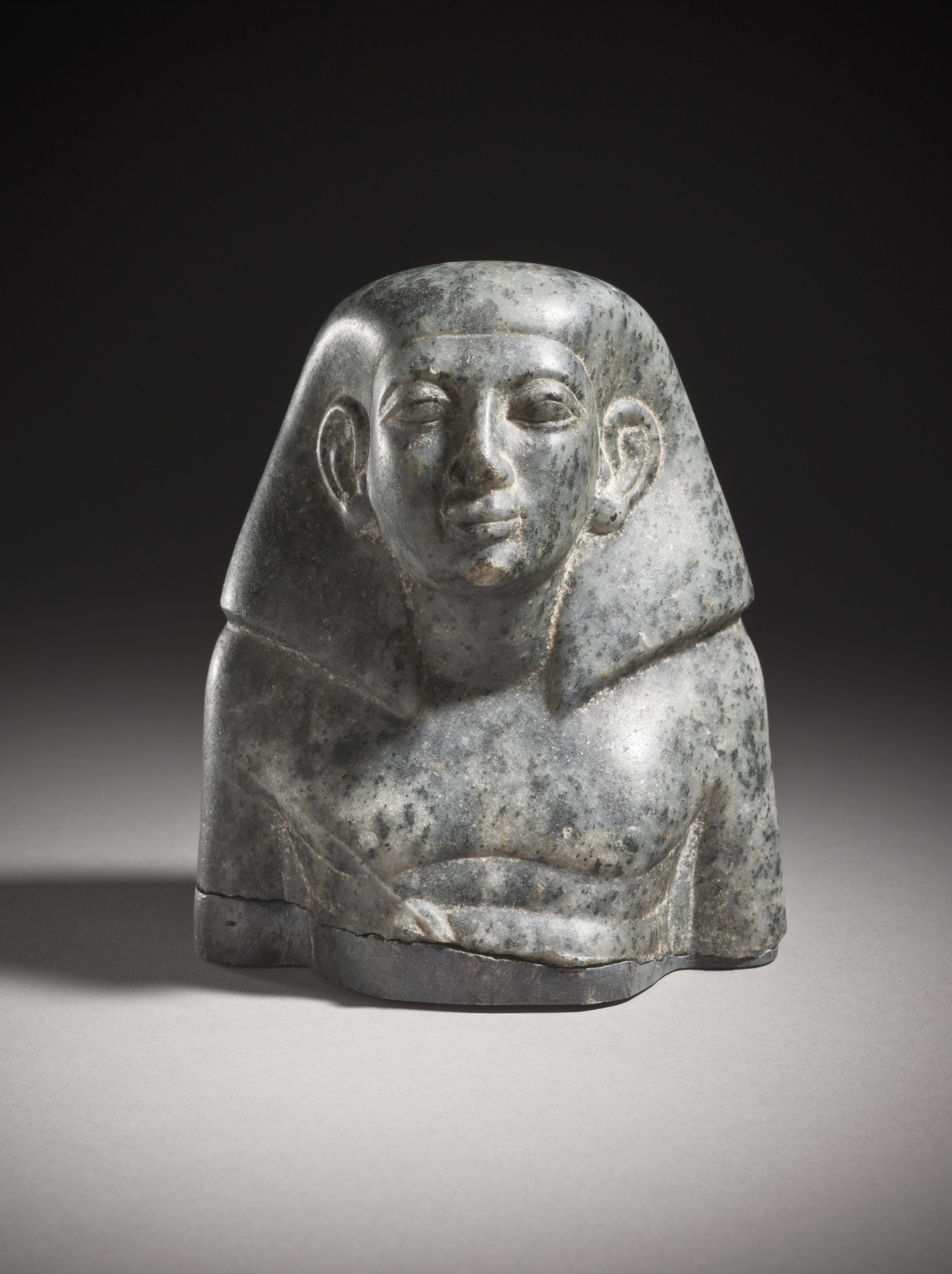 an ancient stone sculpture, the head of a sphinx