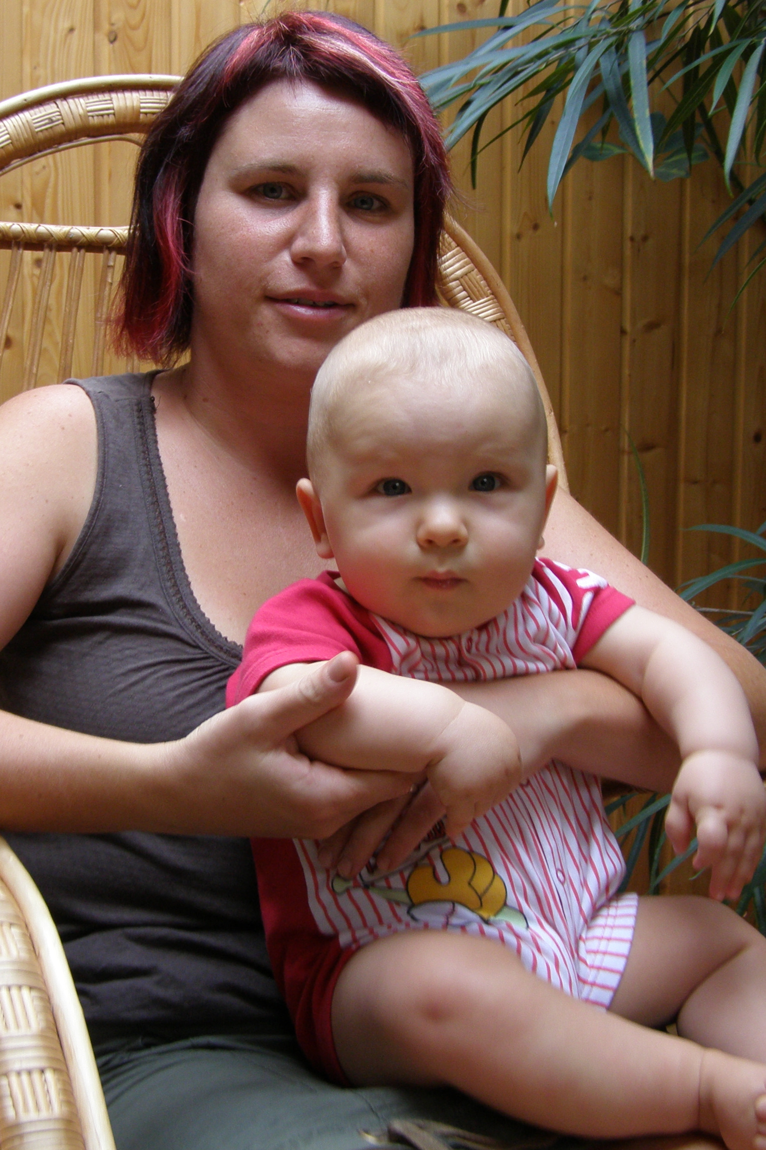a woman with red hair holds a baby