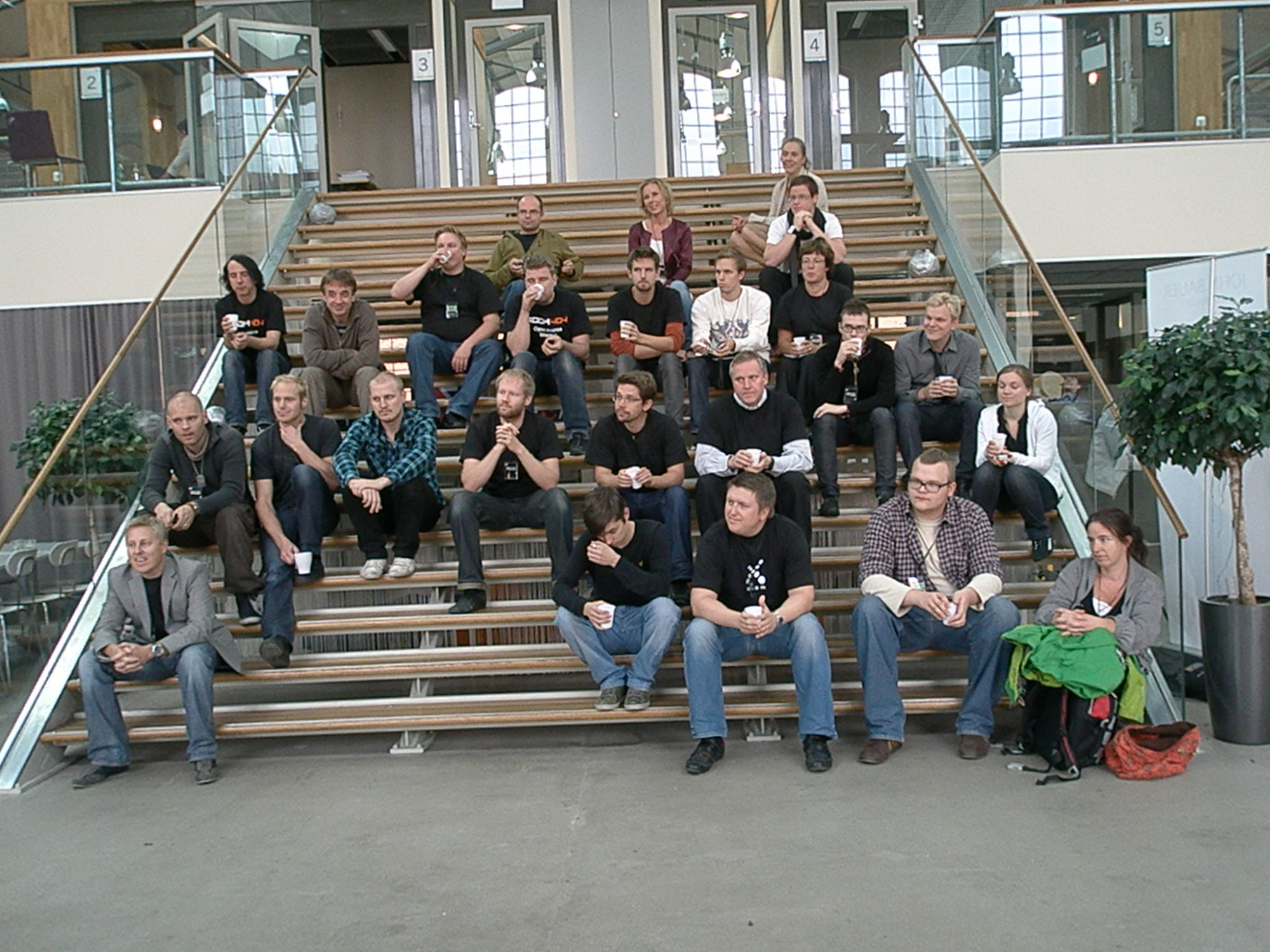 group of people posing on the steps next to steps with beer and soda