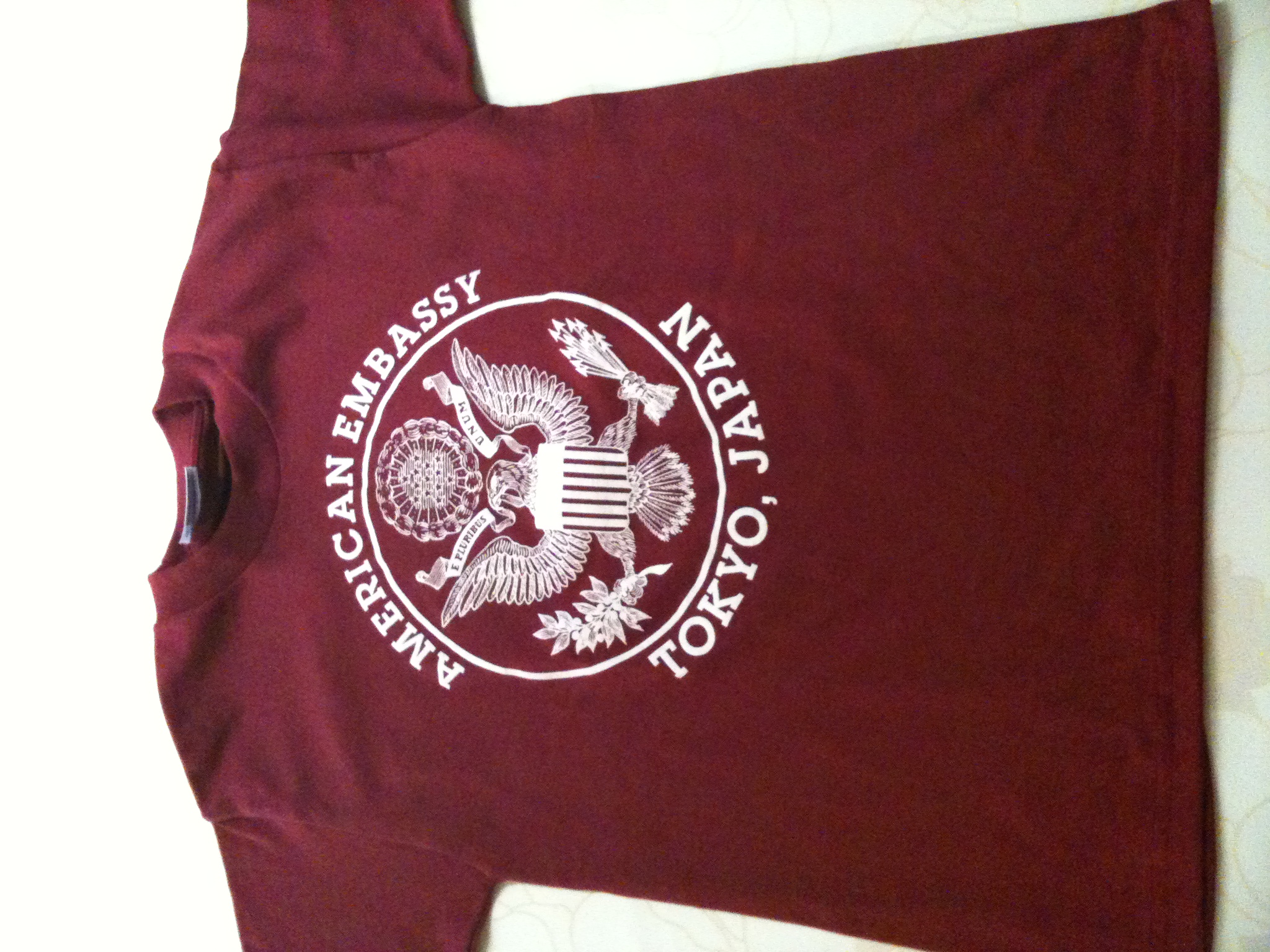 a maroon tshirt with white crest of michigan