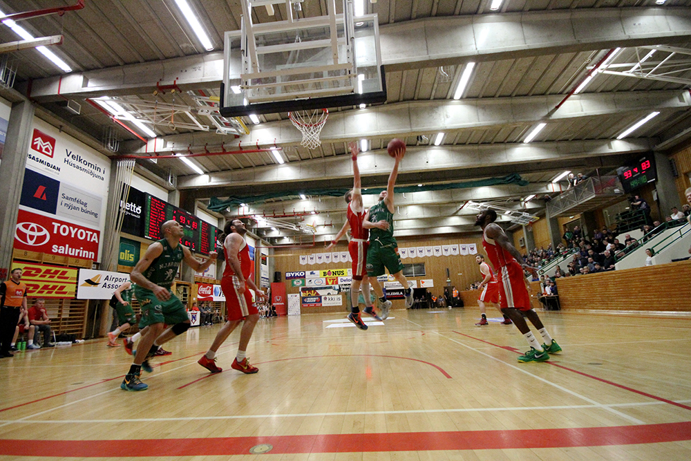 several people are playing basketball on the court