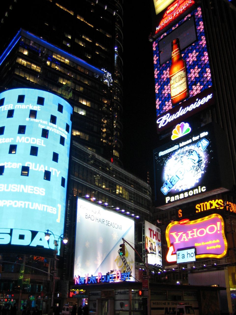 a city street with a lot of neon lights and buildings