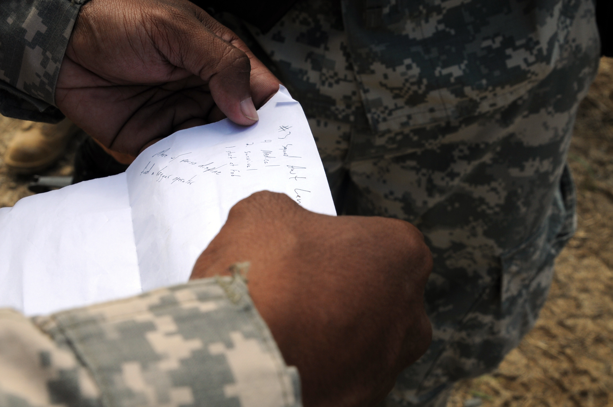 a man in uniform is writing on the envelope