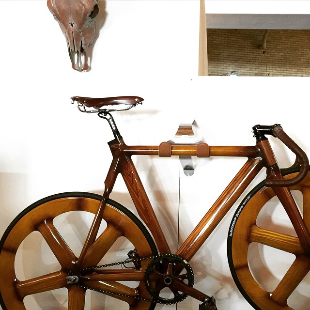 a large wooden bicycle is on display in a home