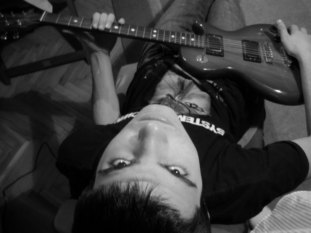 a person laying on the ground with an electric guitar