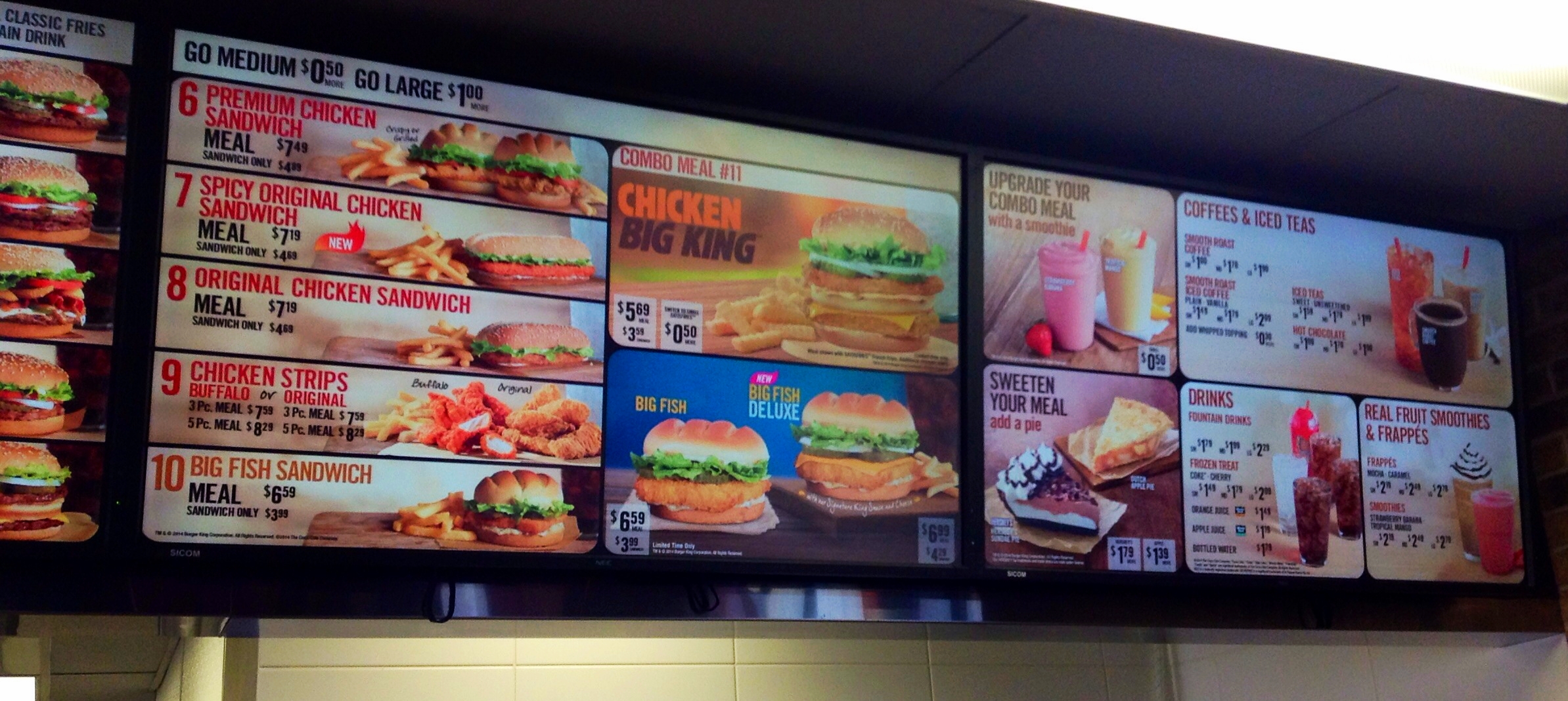 multiple menus are placed on the wall of the restaurant