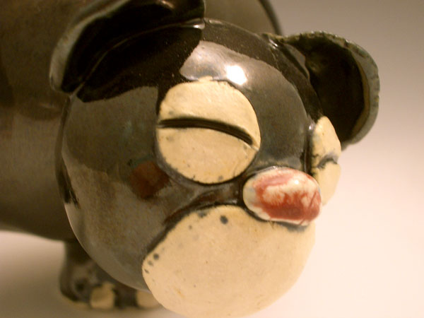 a small black and white pig figure on a table