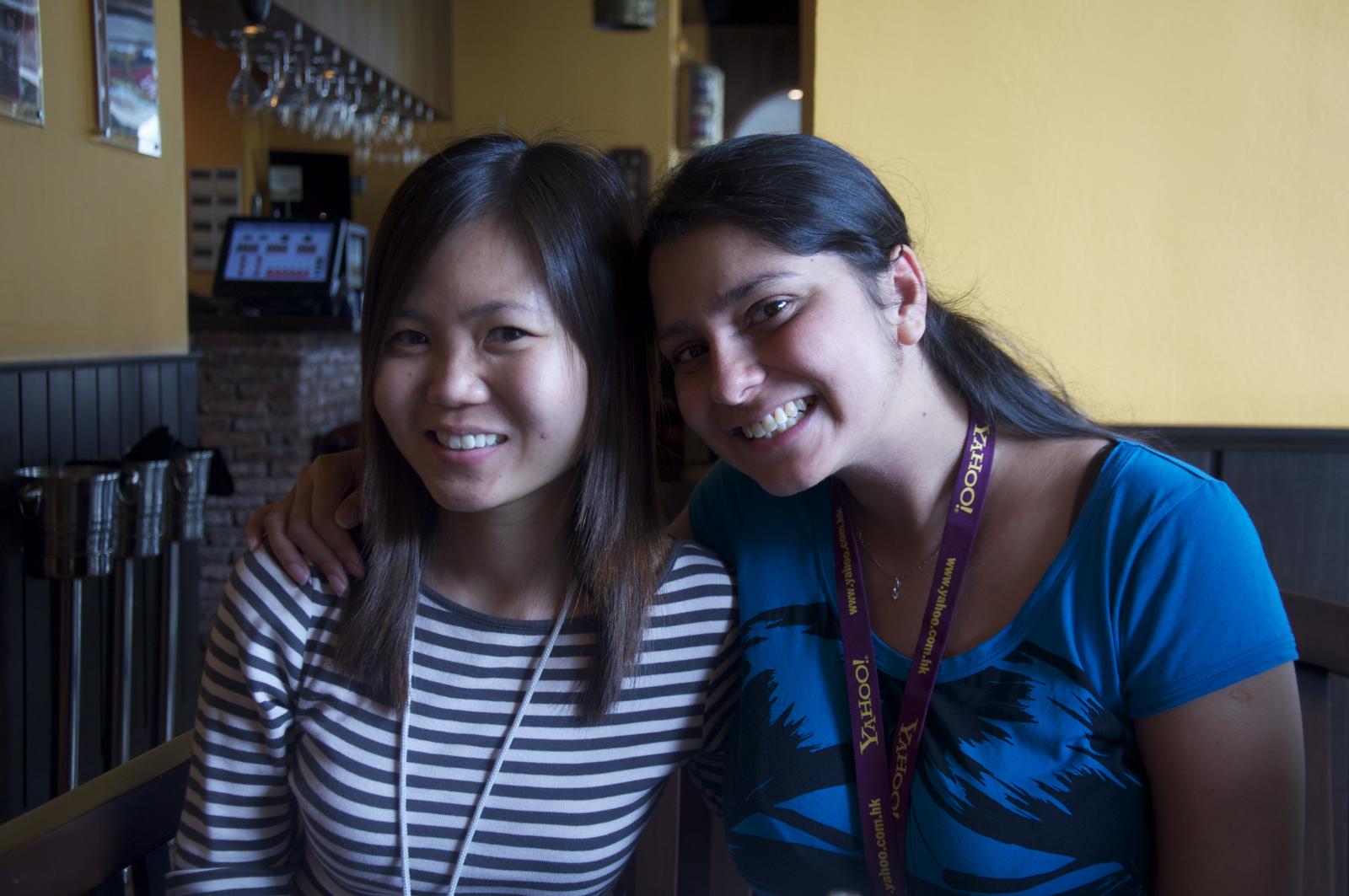 two women sitting in a booth with drinks