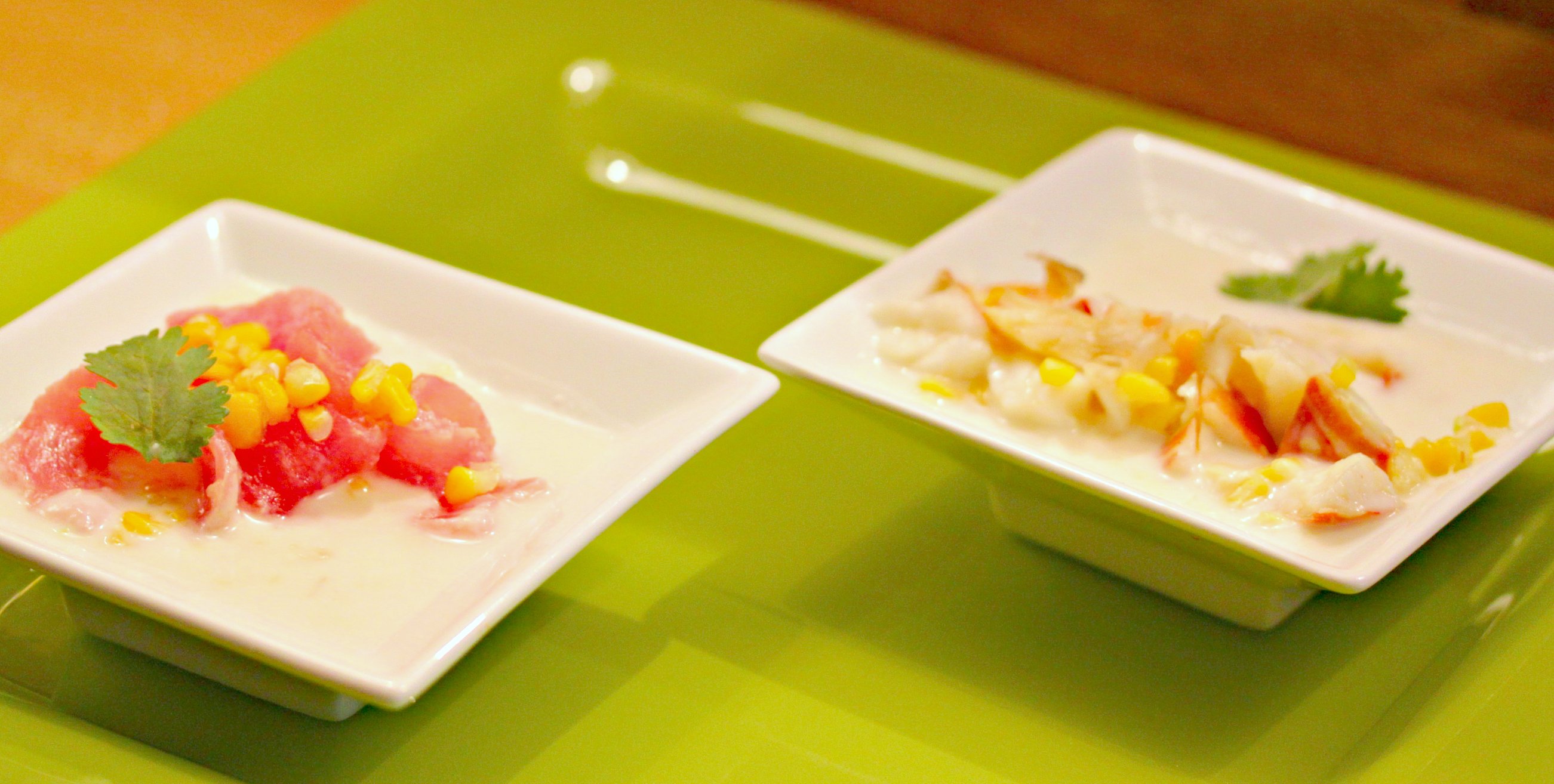 two square dishes with fruit and garnishments on them
