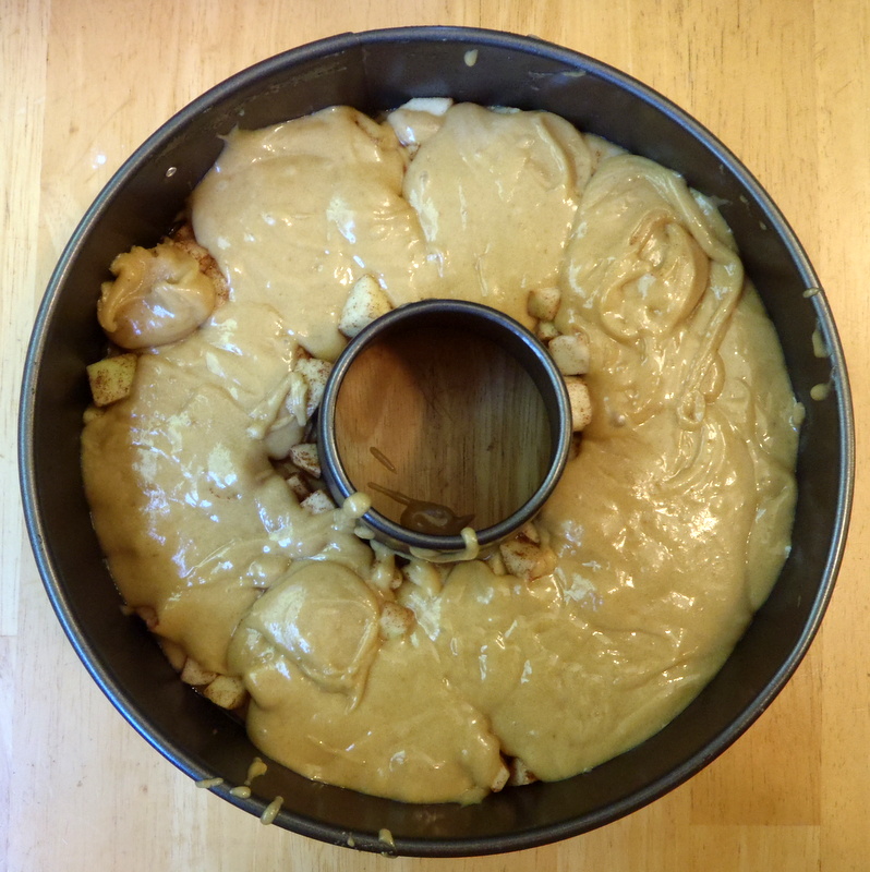 a cake tin with frosting on it and some dough