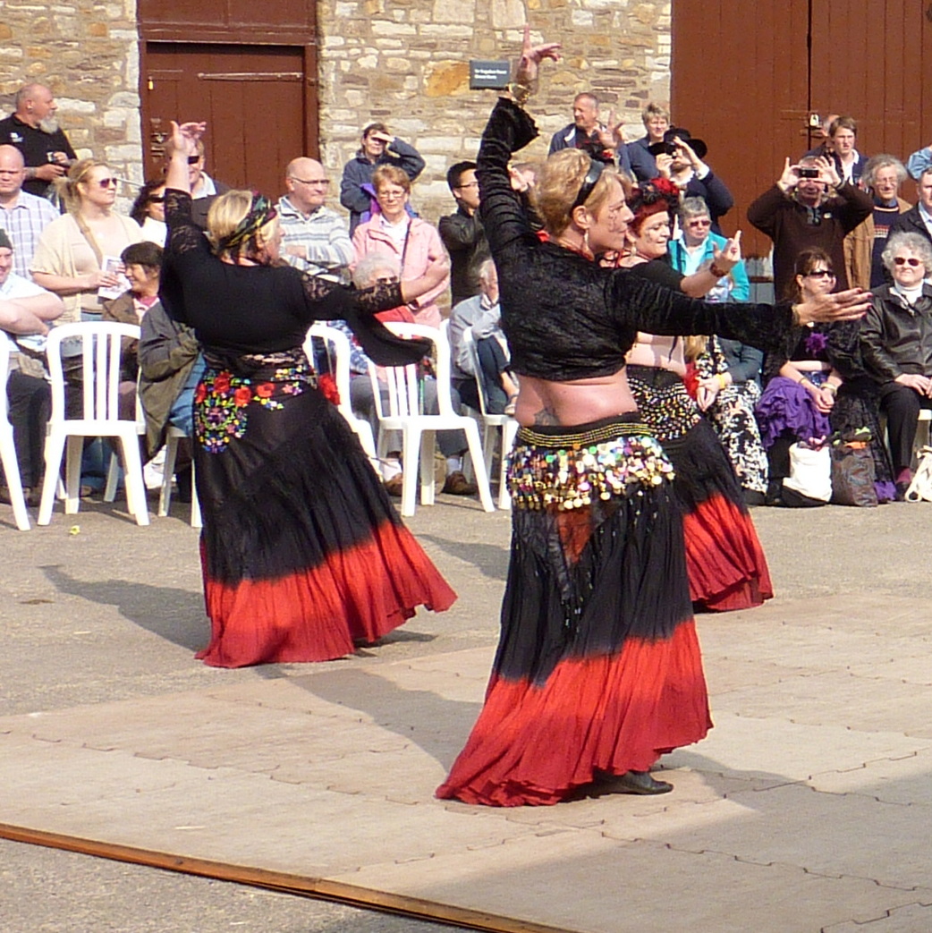 a couple of people dancing together near an audience