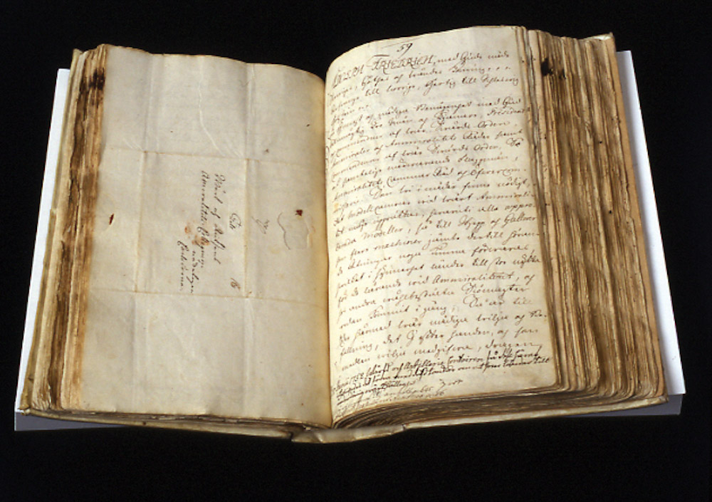 an old open book with a handwritten text