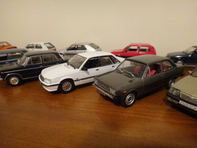 some cars are displayed in the middle of a table