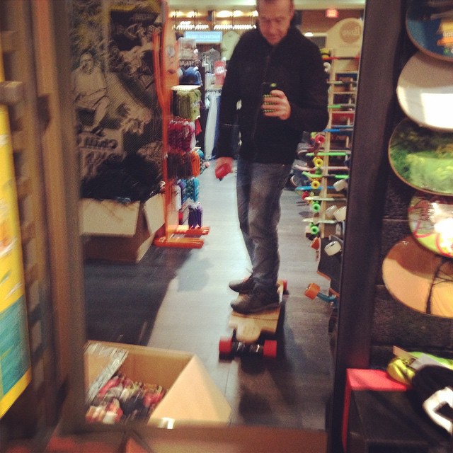 a man riding a skateboard through a store