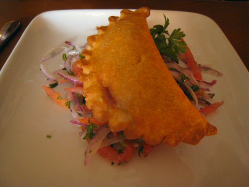 a piece of deep dish fish fillet with fresh salad