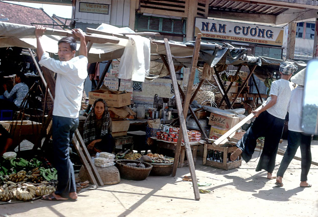 there is a man that is in front of a market